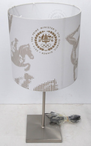 Lot 225 - Modern silver tone Lamp w original 'Prime Minister's 9th Olympic Dinne