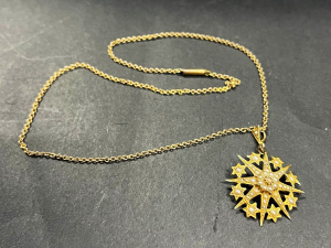 Lot 329 - c1900 9ct gold & seed pearl star burst Pendantbrooch with chain -