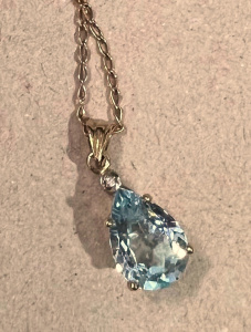 9ct gold chain with 9ct pendant set with blue Topaz and tiny dia - TW 4 8 grms