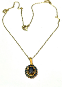 22ct gold pendant set with sapphires, oval centre surrounded by smaller on 14ct